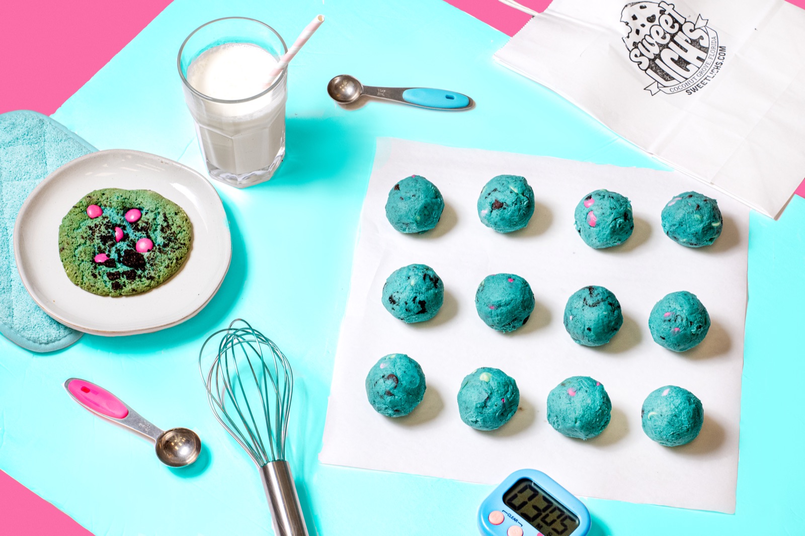 Teal cookie dough balls ready to bake