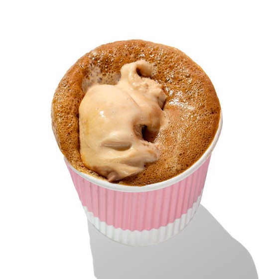 An affogato with espresso poured over ice cream